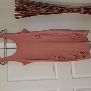Pinkish peach colored dress with cutouts.